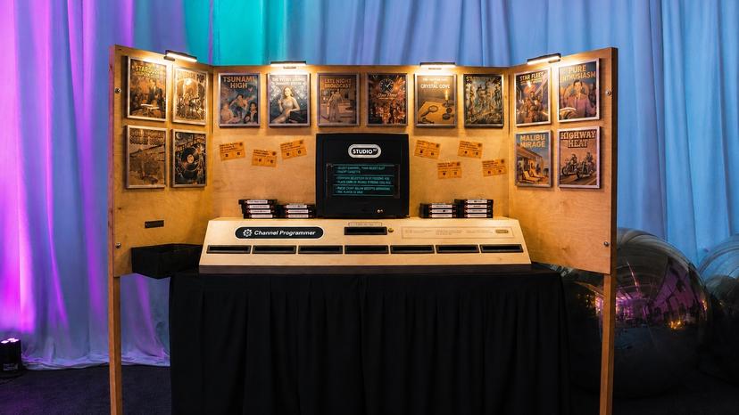 The Channel Programmer station, with cassette slots, themed posters and a physical grid of token slots