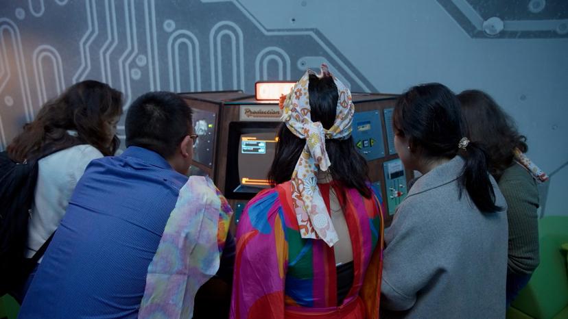 A team at the multi-station Production Console, each guest working a different set of controls